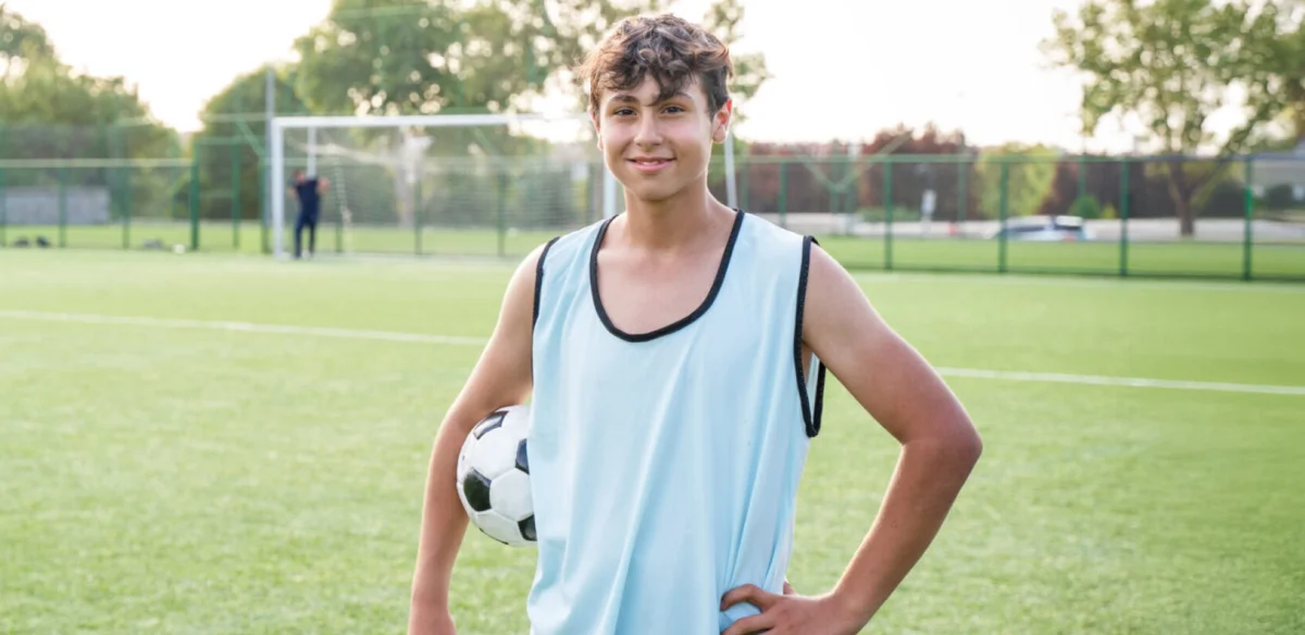 Student holding a soccer ball